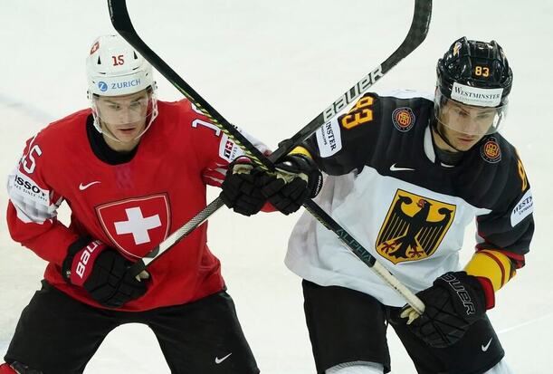 Skřížené hokejky Gregoryho Hofmanna (Švýcarsko) a Leonharda Pfoderla, momentka ze zápasu Švýcarsko vs. Německo na MS v hokeji 2024 (Německo),